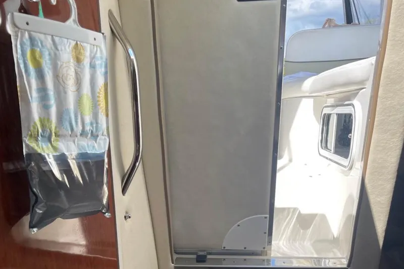 Slide: The Image of Interior view of a 2006 Sea Ray Sundancer 260 boat cabin with seating and storage. - 10