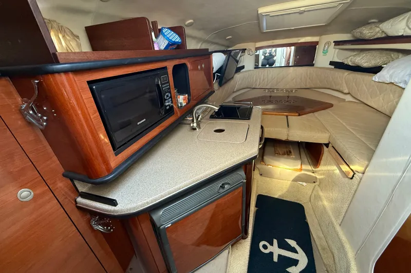 Slide: The Image of Interior of 2006 Sea Ray Sundancer 260 with kitchenette and seating area. - 15