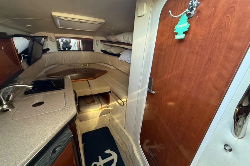 Slide: The Image of 2006 Sea Ray Sundancer 260 cabin interior with kitchenette and seating area. - 17