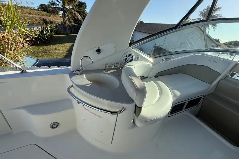 Slide: The Image of 2006 Sea Ray Sundancer 260 interior with seating and sink, featuring sleek design and comfort. - 23