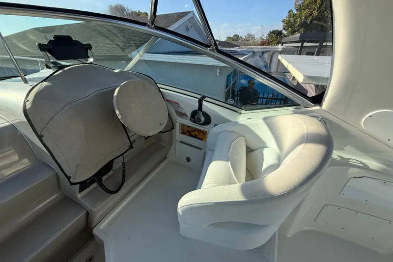 Slide: The Image of Interior view of 2006 Sea Ray Sundancer 260 boat cockpit with white seating. - 24