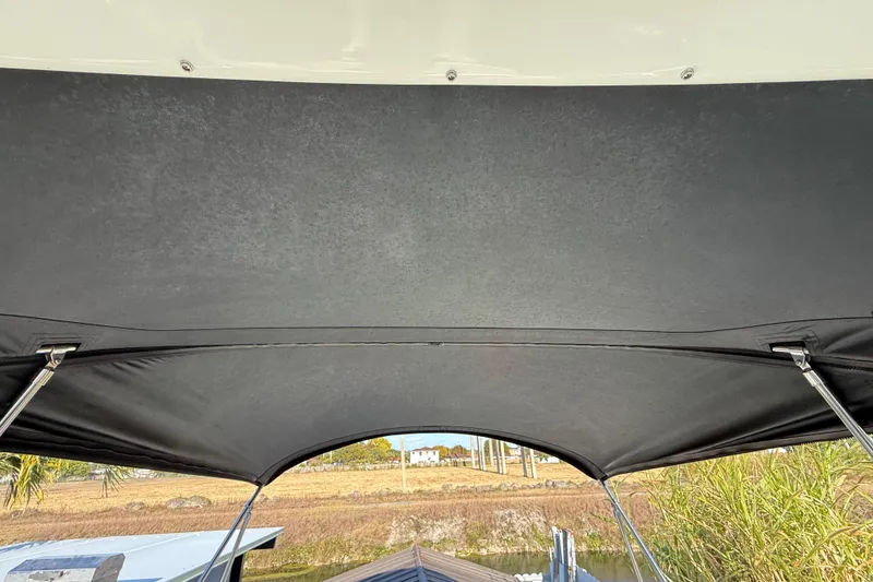 Slide: The Image of 2006 Sea Ray Sundancer 260 boat canopy with scenic outdoor view. - 25