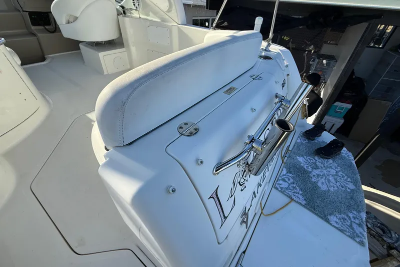 Slide: The Image of 2006 Sea Ray Sundancer 260 boat interior with seating and helm, docked. - 26
