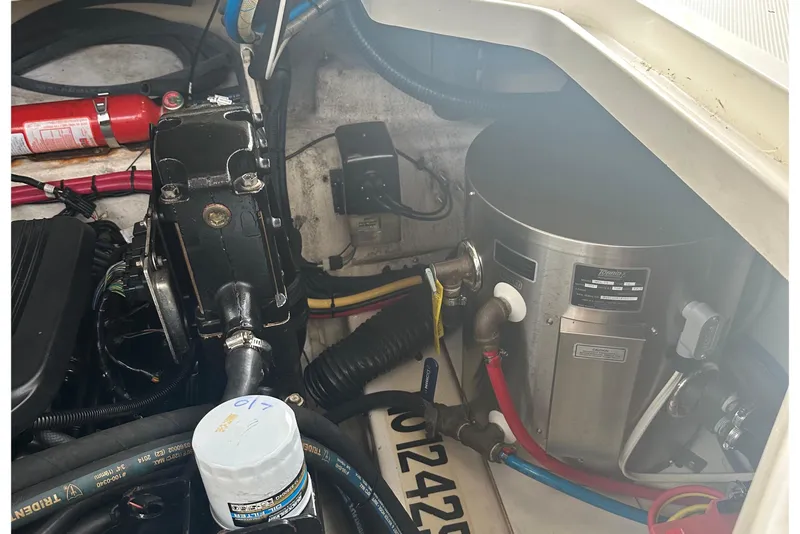 Slide: The Image of Engine compartment of a 2006 Sea Ray Sundancer 260 with visible components and fire extinguisher. - 4