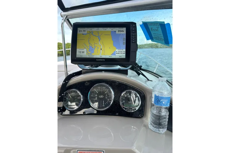 Slide: The Image of Dashboard of 2006 Sea Ray Sundancer 260 with Garmin GPS and water bottle. - 5