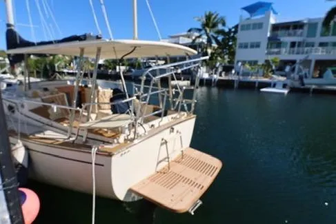 Slide: The Image of 1989 Island Packet 38 yacht bathroom with wooden cabinets and compact toilet. - 10