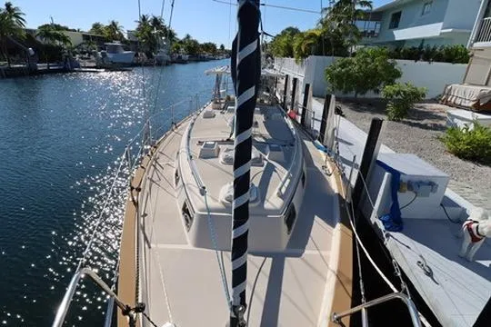 Slide: The Image of 1989 Island Packet 38 yacht bathroom with wooden cabinetry and stainless steel sink. - 14