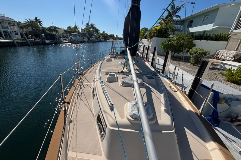 Slide: The Image of 1989 Island Packet 38 interior with wood finish, seating, and kitchen area. - 3