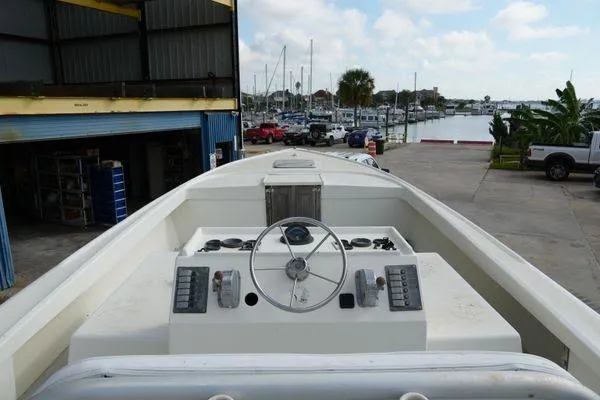 Slide: The Image of 1978 Bertram 31 Sportfisher boat docked at marina, view of helm and controls. - 3