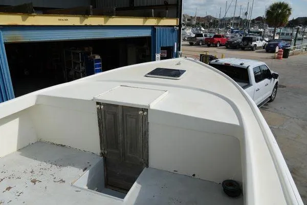 Slide: The Image of 1978 Bertram 31 Sportfisher boat docked near a marina, viewed from above. - 4
