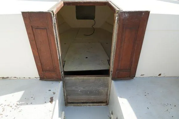 Slide: The Image of 1978 Bertram 31 Sportfisher cabin entrance with wooden doors, showing interior space. - 6