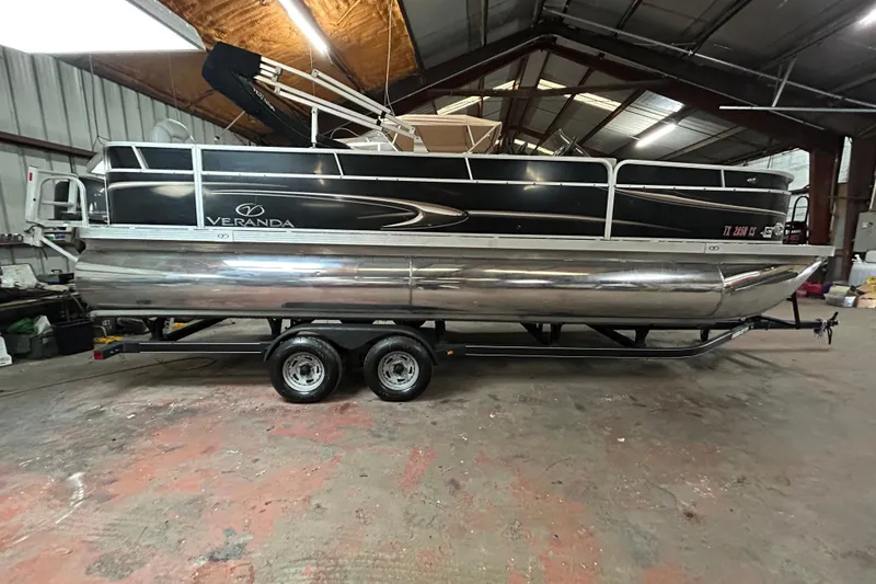 The Image of 2014 Veranda Fishing V2075-F2 pontoon boat on trailer, parked outdoors. - 0