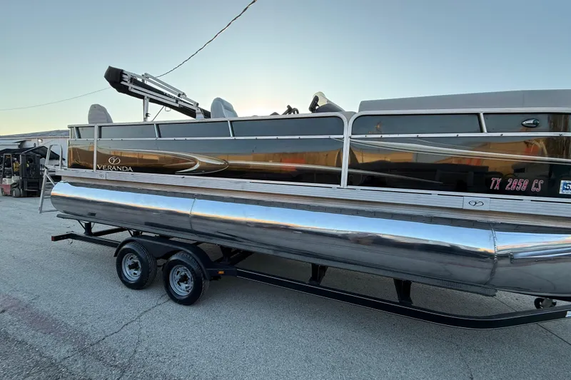Slide: The Image of 2014 Veranda Fishing V2075-F2 pontoon boat on trailer, parked outdoors. - 23