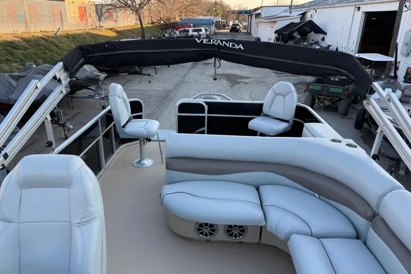 Slide: The Image of 2014 Veranda Fishing V2075-F2 pontoon boat with plush seating and canopy in a storage area. - 41