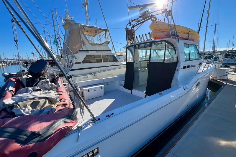 Slide: The Image of 1998 Baha Cruisers 340 CAT docked at marina under clear blue sky. - 10