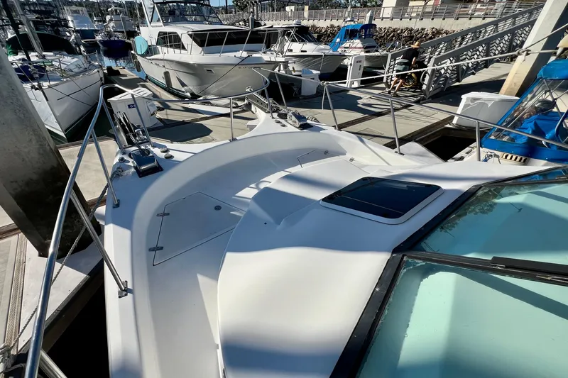 Slide: The Image of 1998 Baha Cruisers 340 CAT docked at marina, surrounded by other boats. - 17