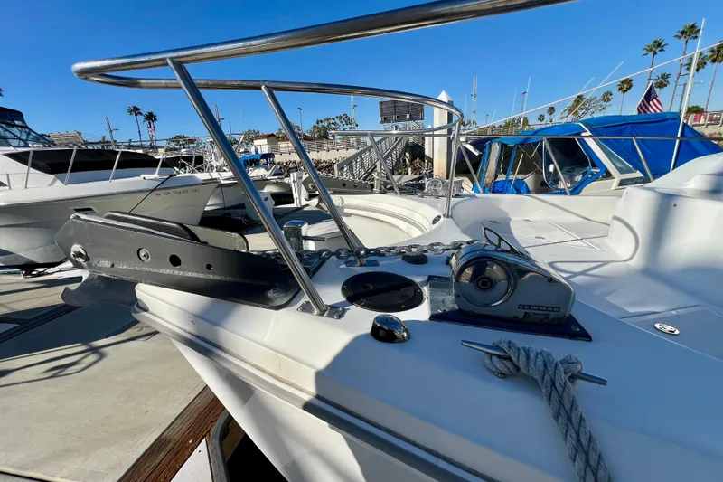 Slide: The Image of 1998 Baha Cruisers 340 CAT boat docked, featuring anchor and winch on deck. - 21
