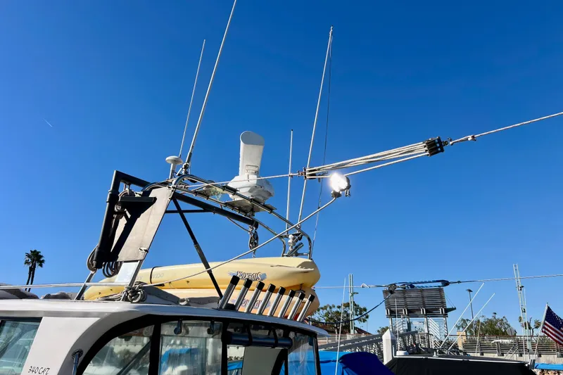 Slide: The Image of 1998 Baha Cruisers 340 CAT boat with antennas and equipment against clear blue sky. - 23