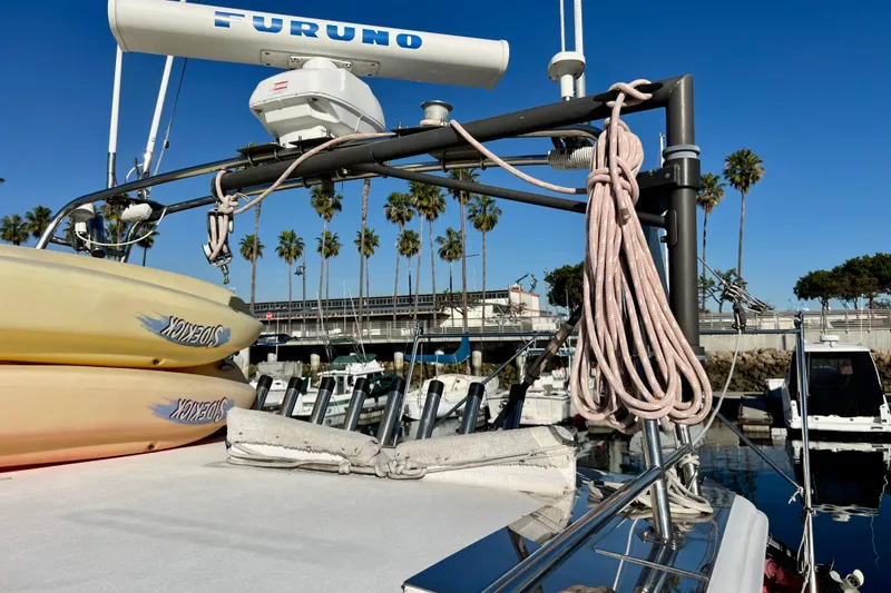 Slide: The Image of 1998 Baha Cruisers 340 CAT with kayaks and ropes docked at marina. - 24