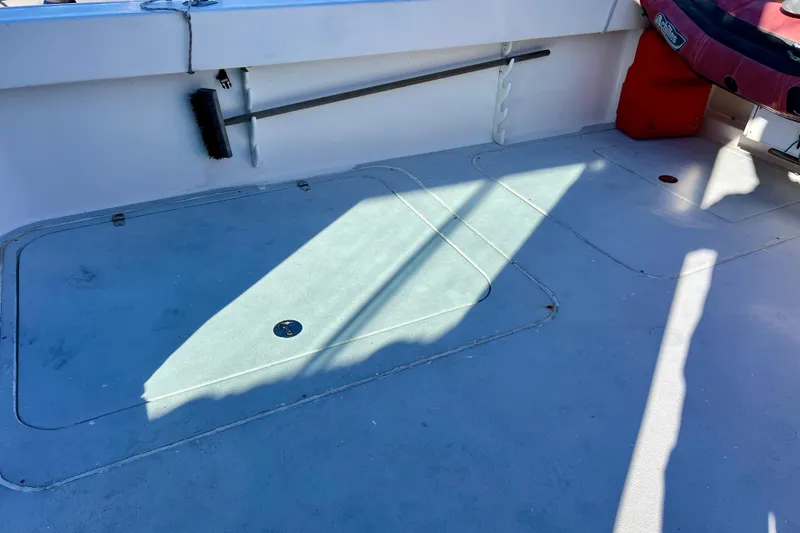 Slide: The Image of 1998 Baha Cruisers 340 CAT boat deck with storage compartments and cleaning brush. - 25