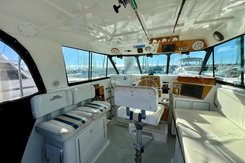 Slide: The Image of Interior of a 1998 Baha Cruisers 340 CAT boat with helm and seating area. - 27