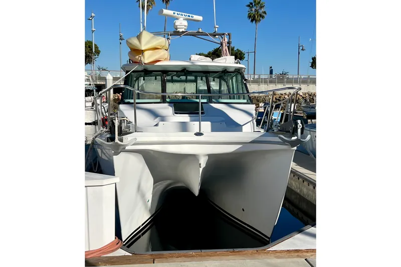 Slide: The Image of 1998 Baha Cruisers 340 CAT boat docked at marina, front view. - 3