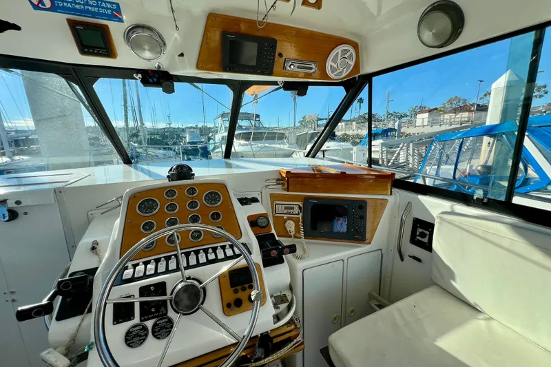 Slide: The Image of Interior view of 1998 Baha Cruisers 340 CAT boat cockpit with steering wheel and controls. - 30