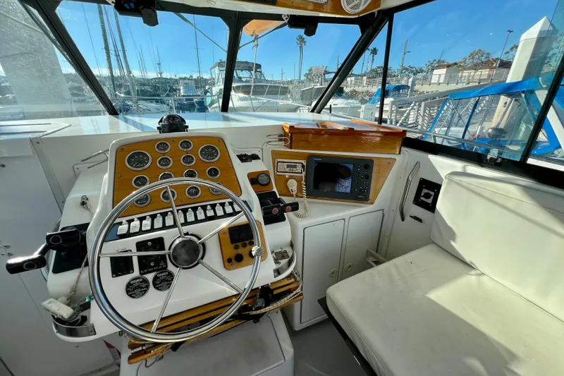 Slide: The Image of Cockpit of 1998 Baha Cruisers 340 CAT with steering wheel and navigation instruments. - 31
