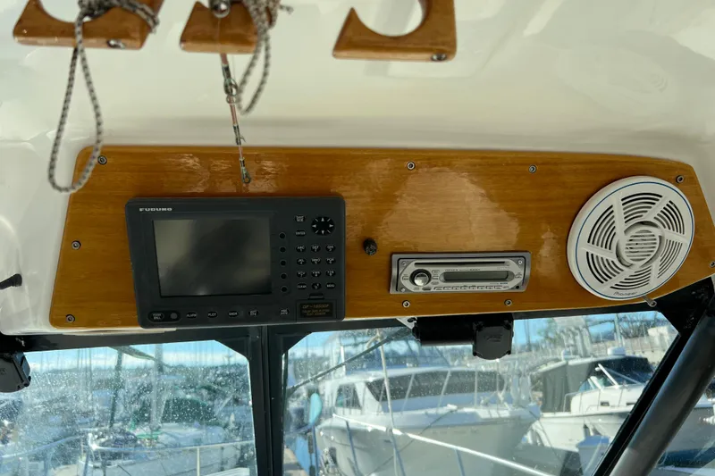 Slide: The Image of 1998 Baha Cruisers 340 CAT dashboard with navigation system and speaker. - 32