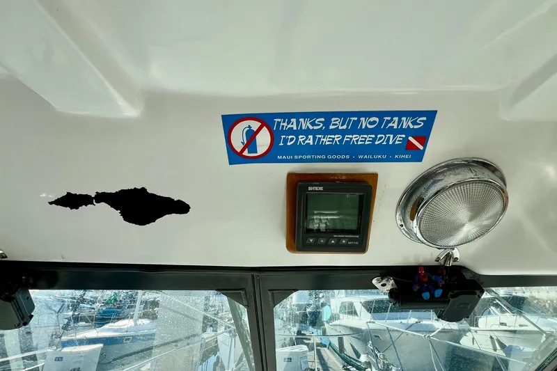 Slide: The Image of 1998 Baha Cruisers 340 CAT interior with diving sticker and navigation equipment. - 33