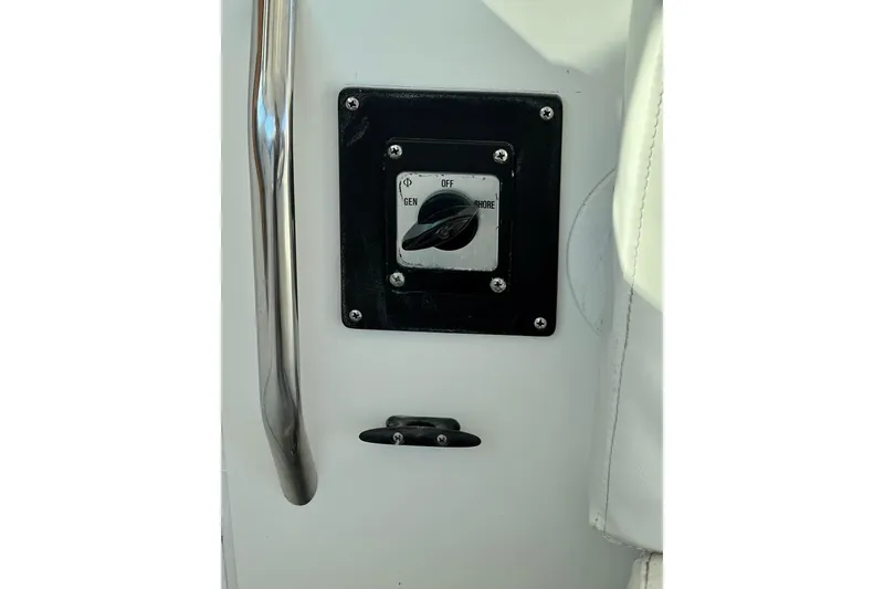 Slide: The Image of Control panel on a 1998 Baha Cruisers 340 CAT boat, featuring a switch and handle. - 34