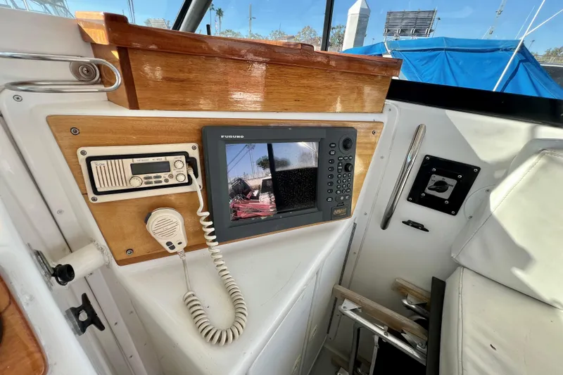 Slide: The Image of 1998 Baha Cruisers 340 CAT cockpit with navigation equipment and radio system. - 35