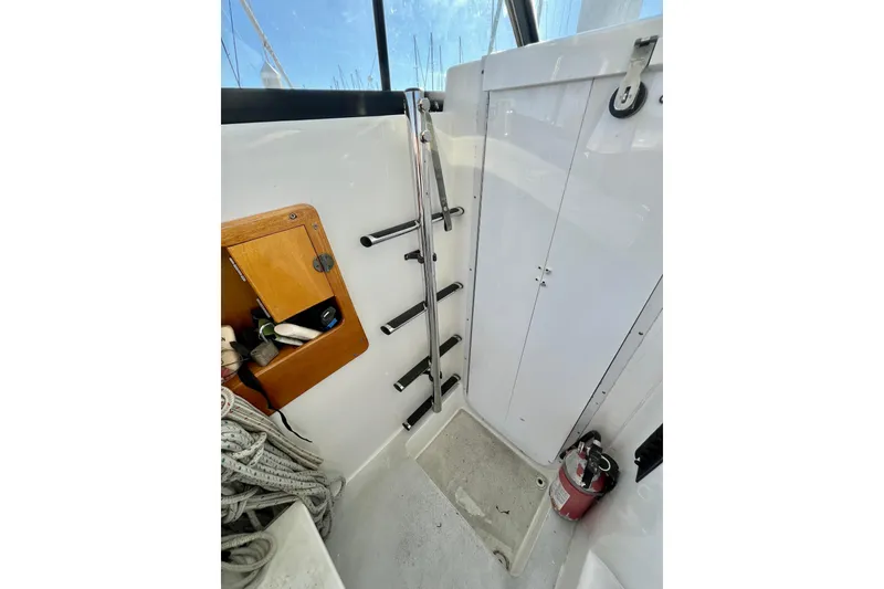 Slide: The Image of Interior of 1998 Baha Cruisers 340 CAT with ladder, storage, and fire extinguisher. - 38