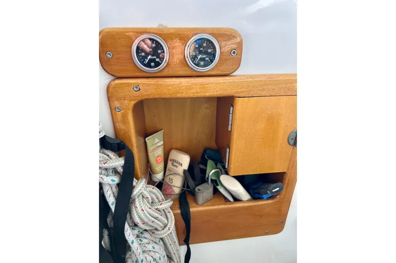 Slide: The Image of Wooden storage compartment on 1998 Baha Cruisers 340 CAT boat with gauges and accessories. - 39