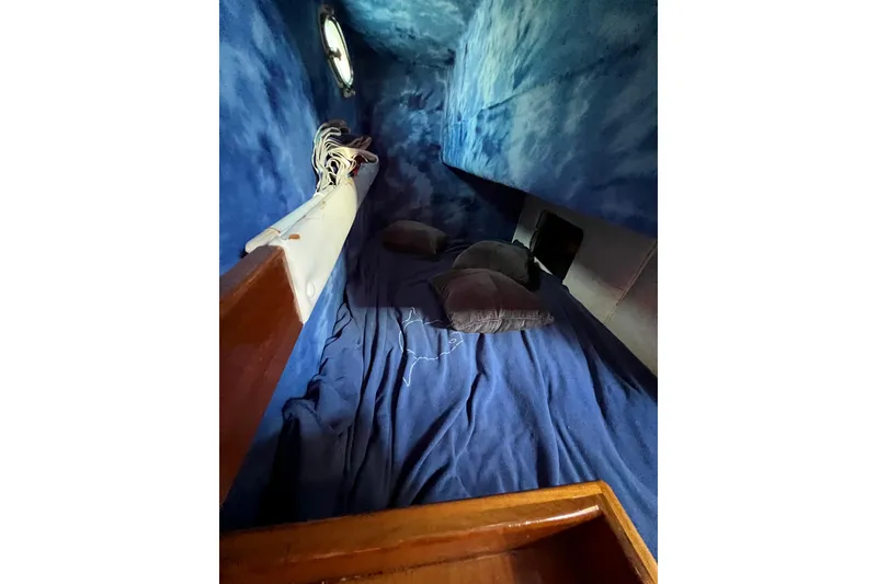 Slide: The Image of 1998 Baha Cruisers 340 CAT cabin interior with blue bedding and wooden accents. - 47