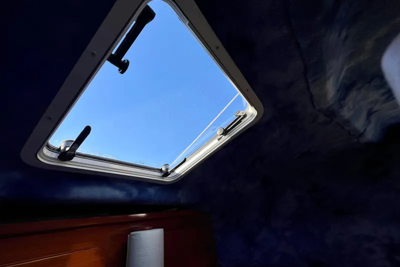 Slide: The Image of Interior view of 1998 Baha Cruisers 340 CAT boat hatch with clear blue sky. - 50