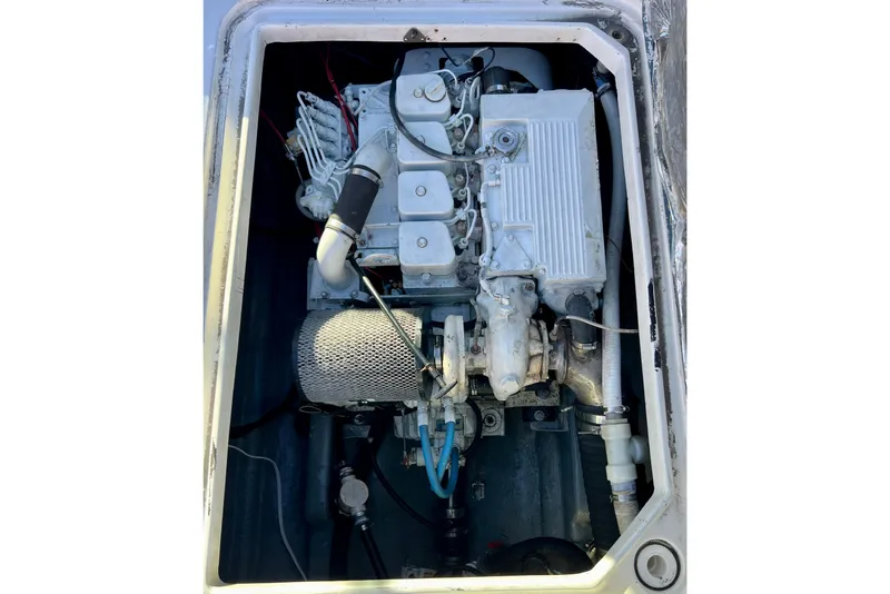Slide: The Image of Engine compartment of a 1998 Baha Cruisers 340 CAT boat, showcasing mechanical components. - 54
