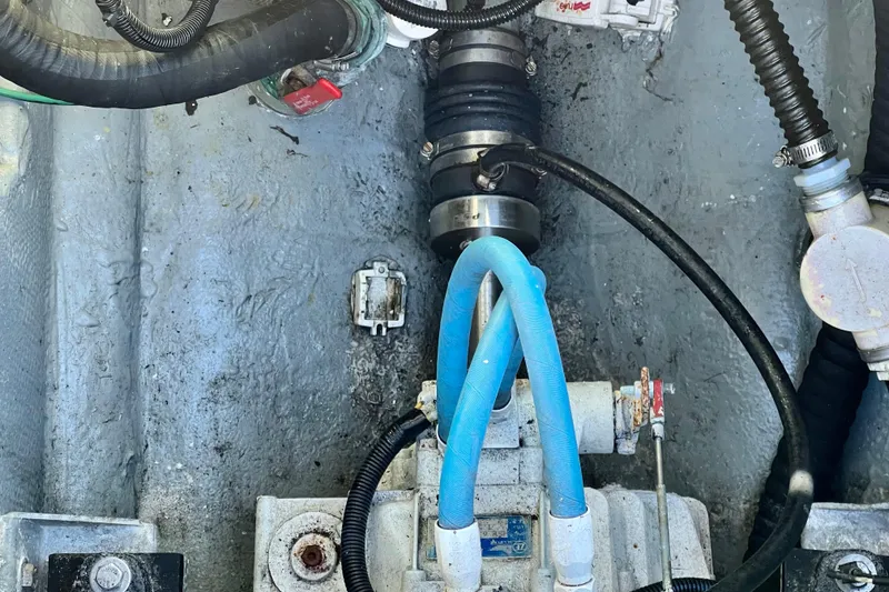 Slide: The Image of Engine compartment of a 1998 Baha Cruisers 340 CAT with visible hoses and components. - 56