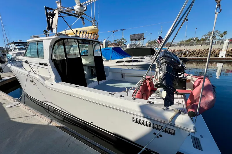 Slide: The Image of 1998 Baha Cruisers 340 CAT boat docked at marina, clear blue sky. - 6