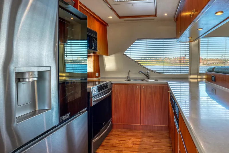 Slide: The Image of Luxurious kitchen interior of 2004 West Bay SonShip 72 Motoryacht with modern appliances and wood cabinetry. - 13