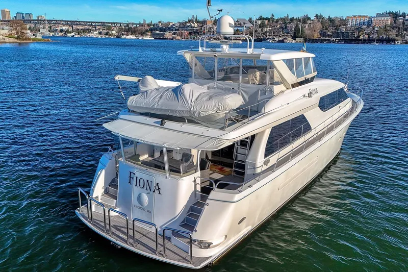 Slide: The Image of 2004 West Bay SonShip 72 Motoryacht on serene water, showcasing luxury and elegance. - 2