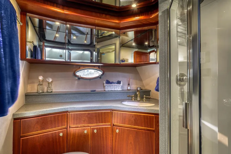 Slide: The Image of Luxurious bathroom in 2004 West Bay SonShip 72 Motoryacht with elegant wood cabinetry and modern fixtures. - 24