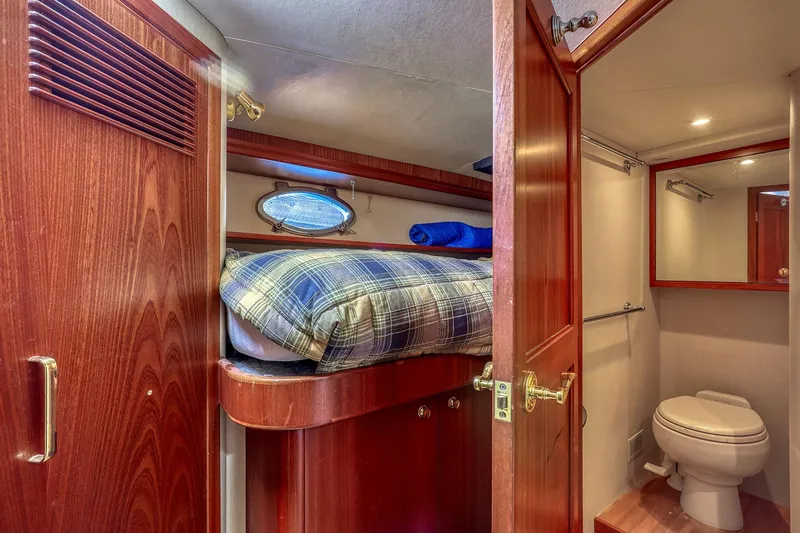 Slide: The Image of Cozy cabin and bathroom in 2004 West Bay SonShip 72 Motoryacht, featuring wood finishes. - 25