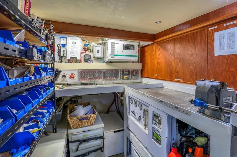 Slide: The Image of Engine room of 2004 West Bay SonShip 72 Motoryacht with organized tools and control panels. - 27