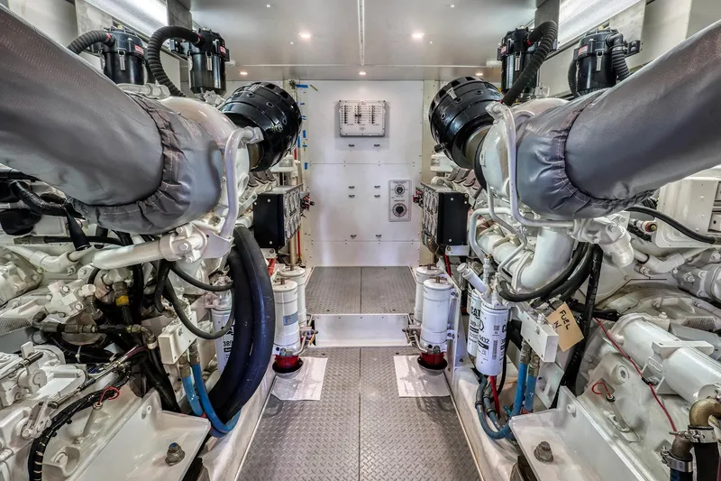 Slide: The Image of Engine room of 2004 West Bay SonShip 72 Motoryacht, showcasing dual engines and mechanical systems. - 28