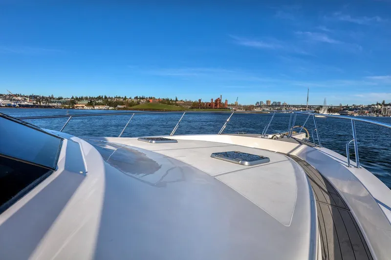 Slide: The Image of 2004 West Bay SonShip 72 Motoryacht cruising on a sunny day with cityscape views. - 4