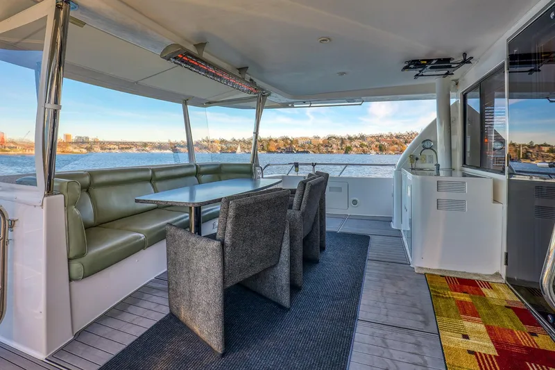 Slide: The Image of Luxurious 2004 West Bay SonShip 72 Motoryacht interior with elegant dining area and scenic water views. - 6