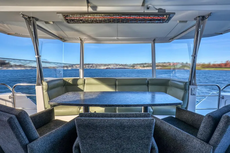 Slide: The Image of Luxurious 2004 West Bay SonShip 72 Motoryacht interior with elegant seating and scenic water view. - 7