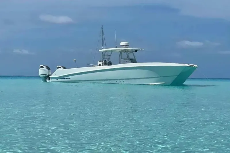 The Image of 2023 Twin Vee 340 GFX CC boat on clear turquoise water under blue sky. - 1