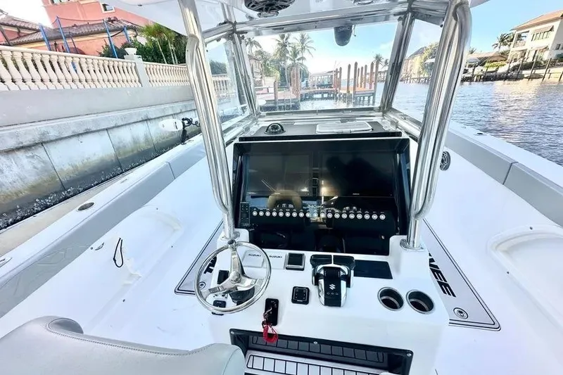 Slide: The Image of 2023 Twin Vee 340 GFX CC boat console with modern controls and waterfront view. - 11